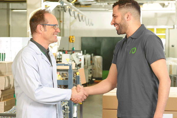 Preventive maintenance provides planning security: Man in a white work coat and service technician shaking hands